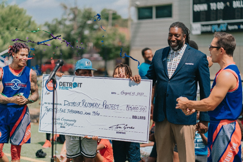 One year ago, Detroit Pistons owner Tom Gores pledged $100K for SAY Detroit kids to distribute to charity. Here is how it will benefit the community