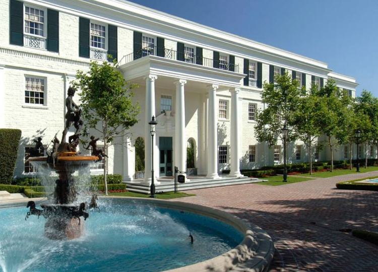 An elegant English Georgian Revival office complex with columns and fountains