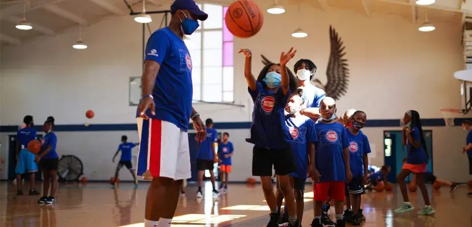 Young people playing basketball on an indoor court