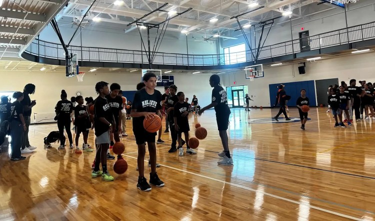 Young people playing basketball on an indoor court