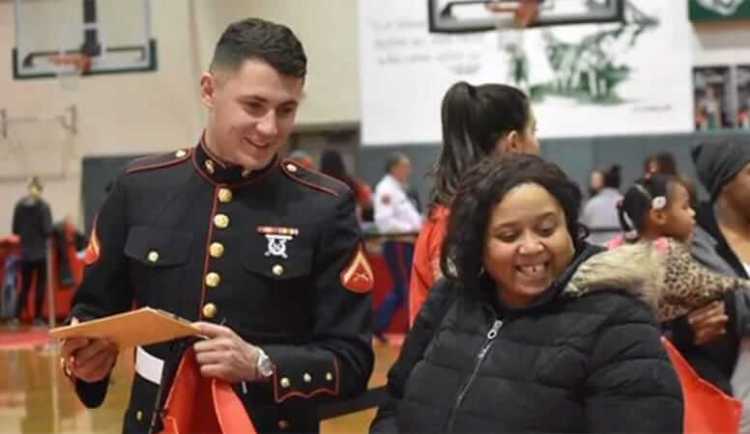 A marine in his dress uniform distributes toys at an event