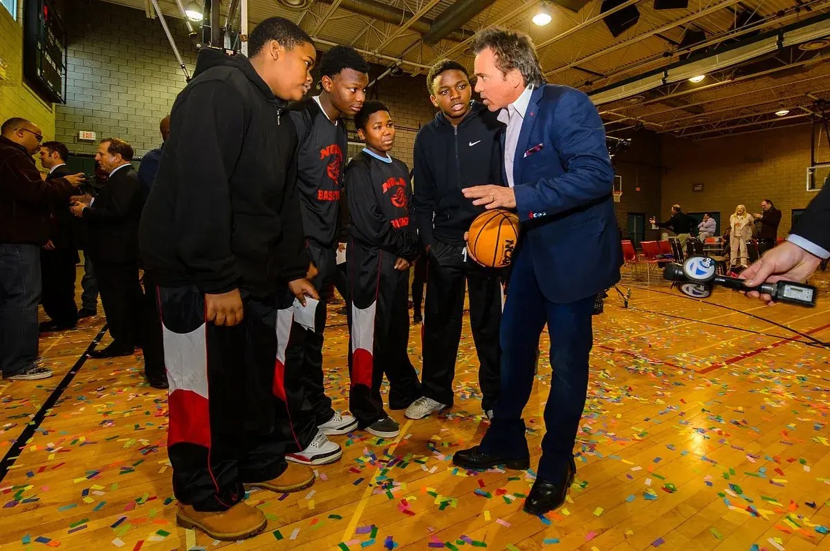 Tom Gores offers tips to a group of young basketball players