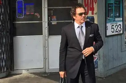 Platinum Equity chairman Tom Gores visits a market in Flint, Michigan