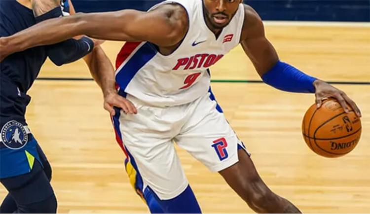 A Detroit Pistons player makes a move toward the net