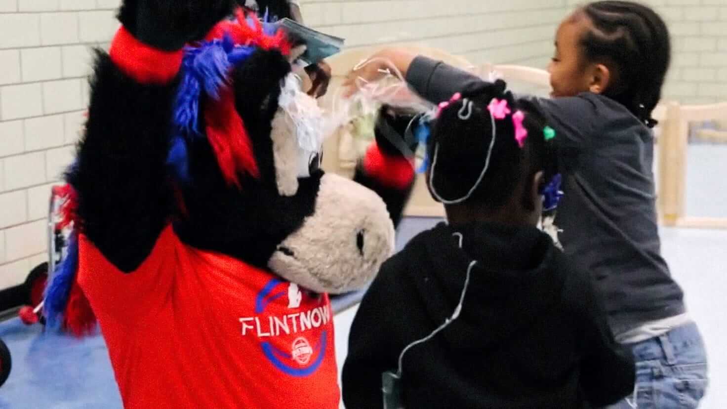 The Pistons mascot, Hooper, greets some kids