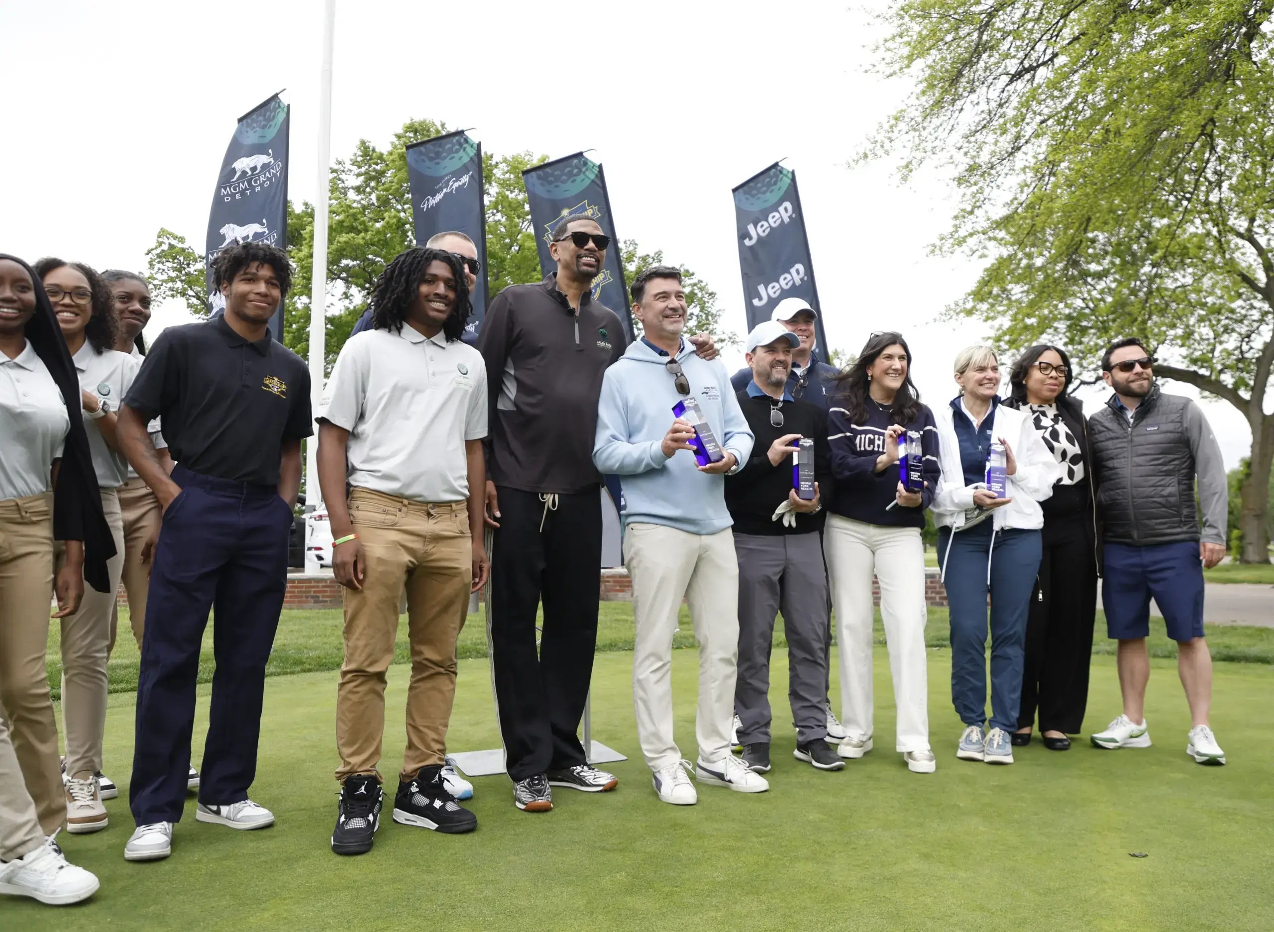 Players on the green at the Jalen Rose Leadership Academy golfing fundraiser