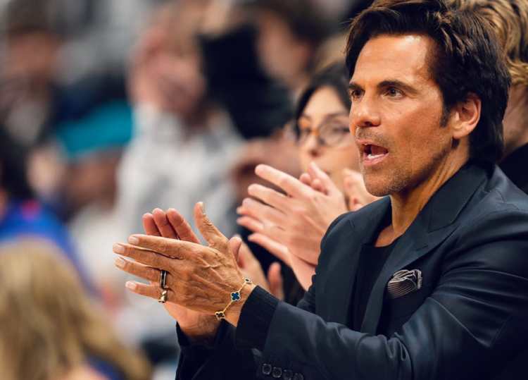 Tom Gores cheering courtside at a Detroit Pistons game